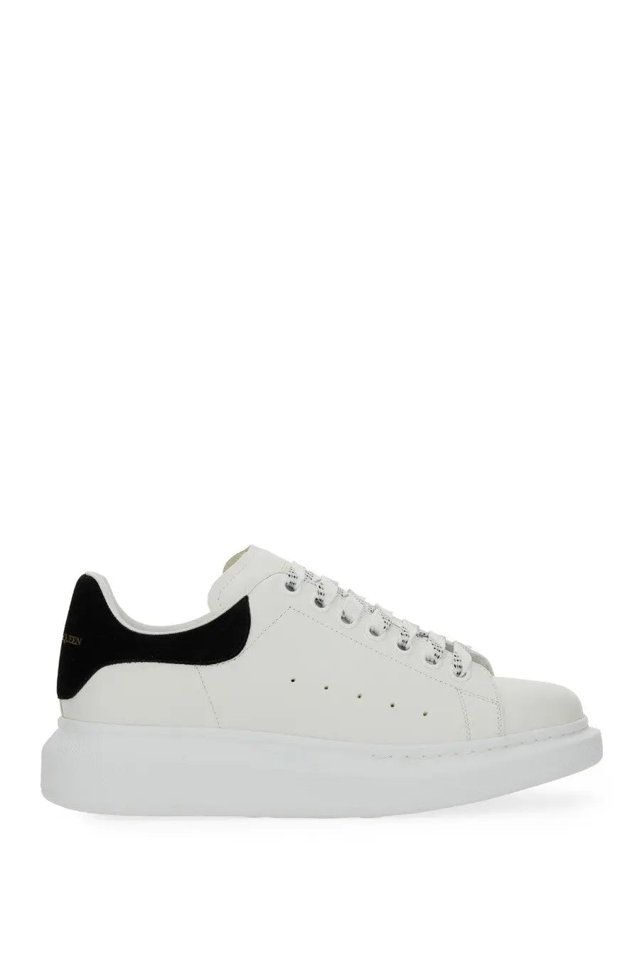 Alexander McQueen women’s oversized white leather sneaker with black suede heel tab and silver-toned eyelets