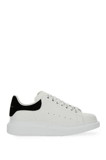 Alexander McQueen women’s oversized white leather sneaker with black suede heel tab and silver-toned eyelets