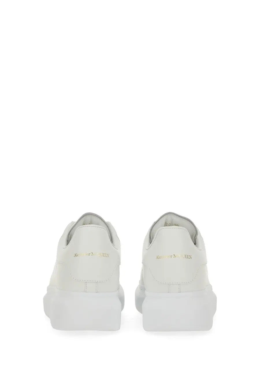 White leather alexander mcqueen womens oversized sneaker with chunky sole and gold branding on the heel back view