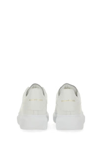 White leather alexander mcqueen womens oversized sneaker with chunky sole and gold branding on the heel back view