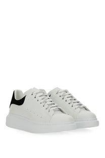 Alexander McQueen women’s oversized sneaker white in white leather with black suede heel tab and silver metallic laces