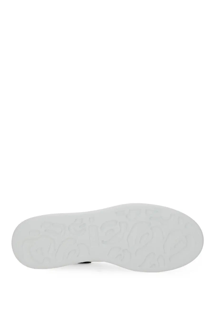 White rubber sole with embossed logo pattern on alexander mcqueen women’s oversized white sneaker