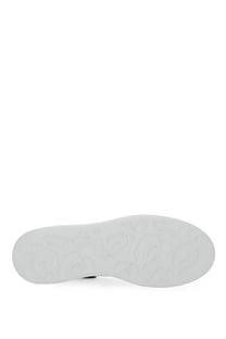 White rubber sole with embossed logo pattern on alexander mcqueen women’s oversized white sneaker