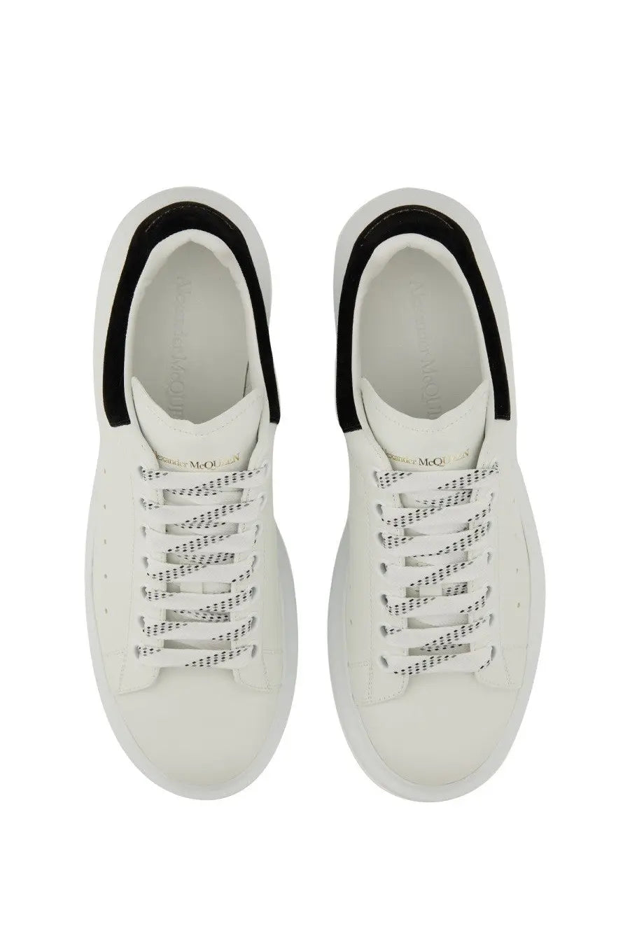 White alexander mcqueen women’s oversized sneaker with black dotted pattern accents on heel collar and laces