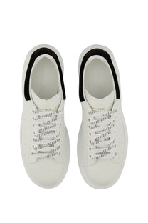 White alexander mcqueen women’s oversized sneaker with black dotted pattern accents on heel collar and laces