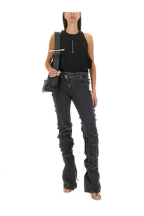 Black denim jeans with distinctive crisscross lacing along the legs paired with alexander mcqueen women’s ribbed tank top black