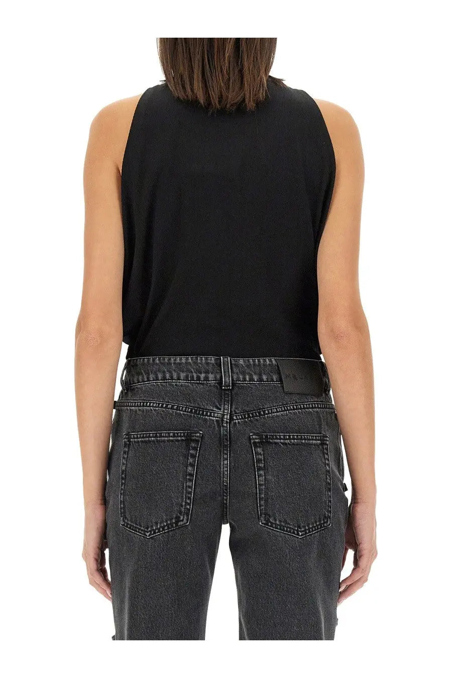 Alexander mcqueen women’s sleeveless ribbed knit tank top in black paired with dark gray denim jeans