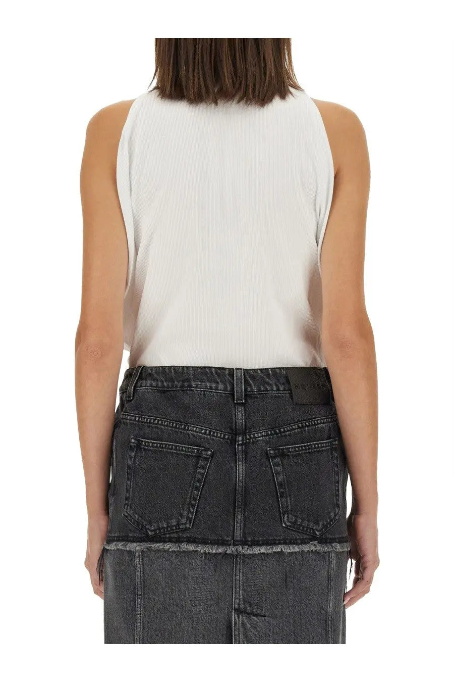 Alexander mcqueen women’s ribbed tank top in white paired with a dark gray denim skirt for casual wear
