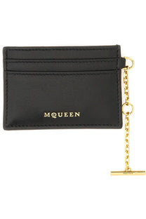 Alexander McQueen women’s black leather sling card holder with gold-tone metal chain, t-bar clasp, and embossed branding