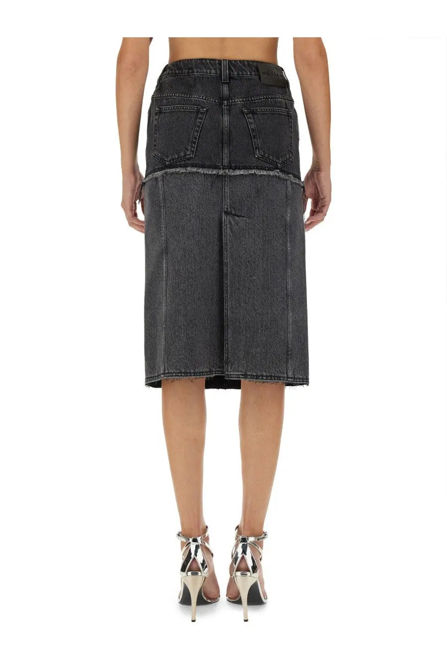 Back side of alexander mcqueen women’s black two tone dark gray denim skirt with frayed hem and two back pockets
