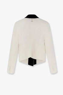 Alexander McQueen women’s wool blazer in cream with black collar and fabric tie shown from the back with long sleeves