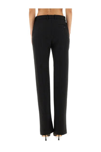 Black tailored wool gabardine trousers by alexander mcqueen with a sleek straight-leg cut and subtle back pleats visible