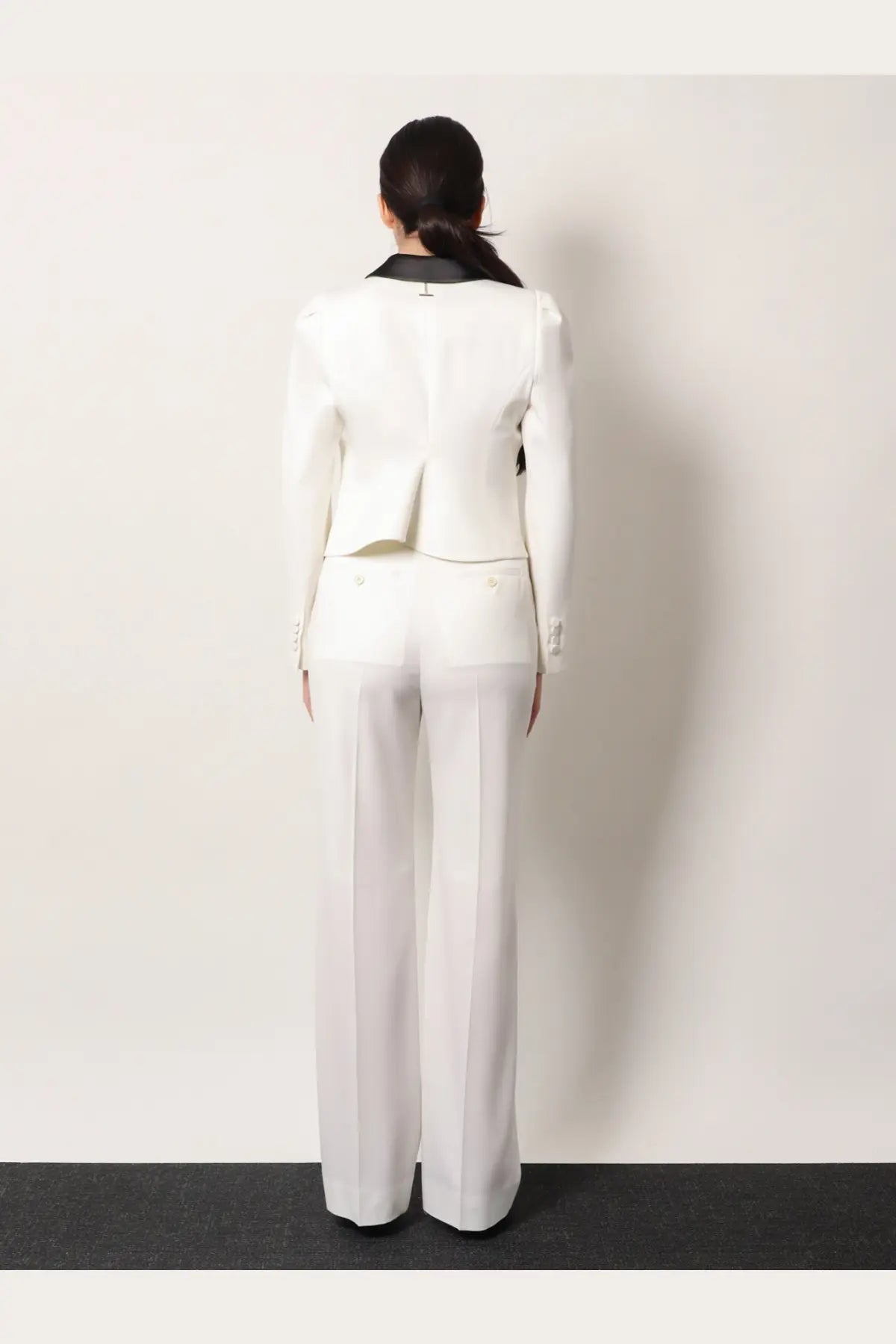 White tailored blazer with black collar and subtle back pleating paired with alexander mcqueen womens wool trousers white