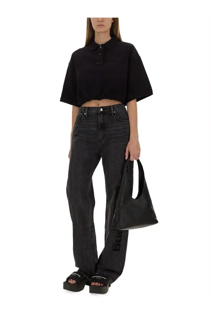 Black leather tote bag with minimalist design and single handle from alexanderwang women’s deconstructed polo black collection