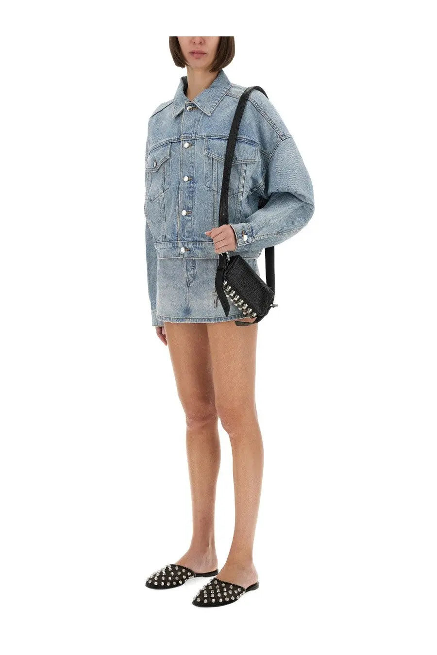 Black studded crossbody bag with silver studs and sleek minimalist design paired with alexanderwang blue denim trucker jacket