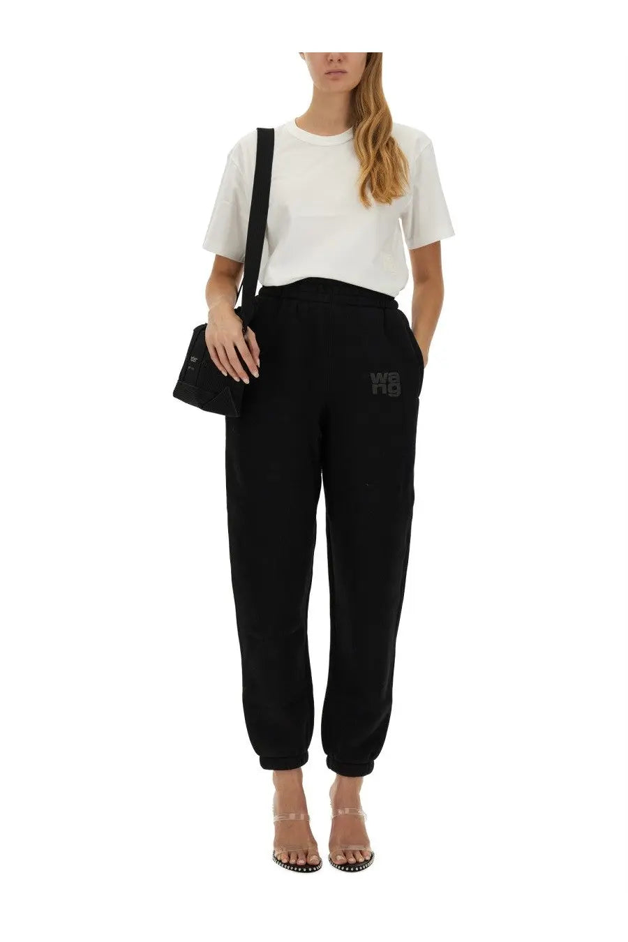Black cotton joggers with subtle embroidered logo on left thigh paired with alexanderwang women’s essential white shirt