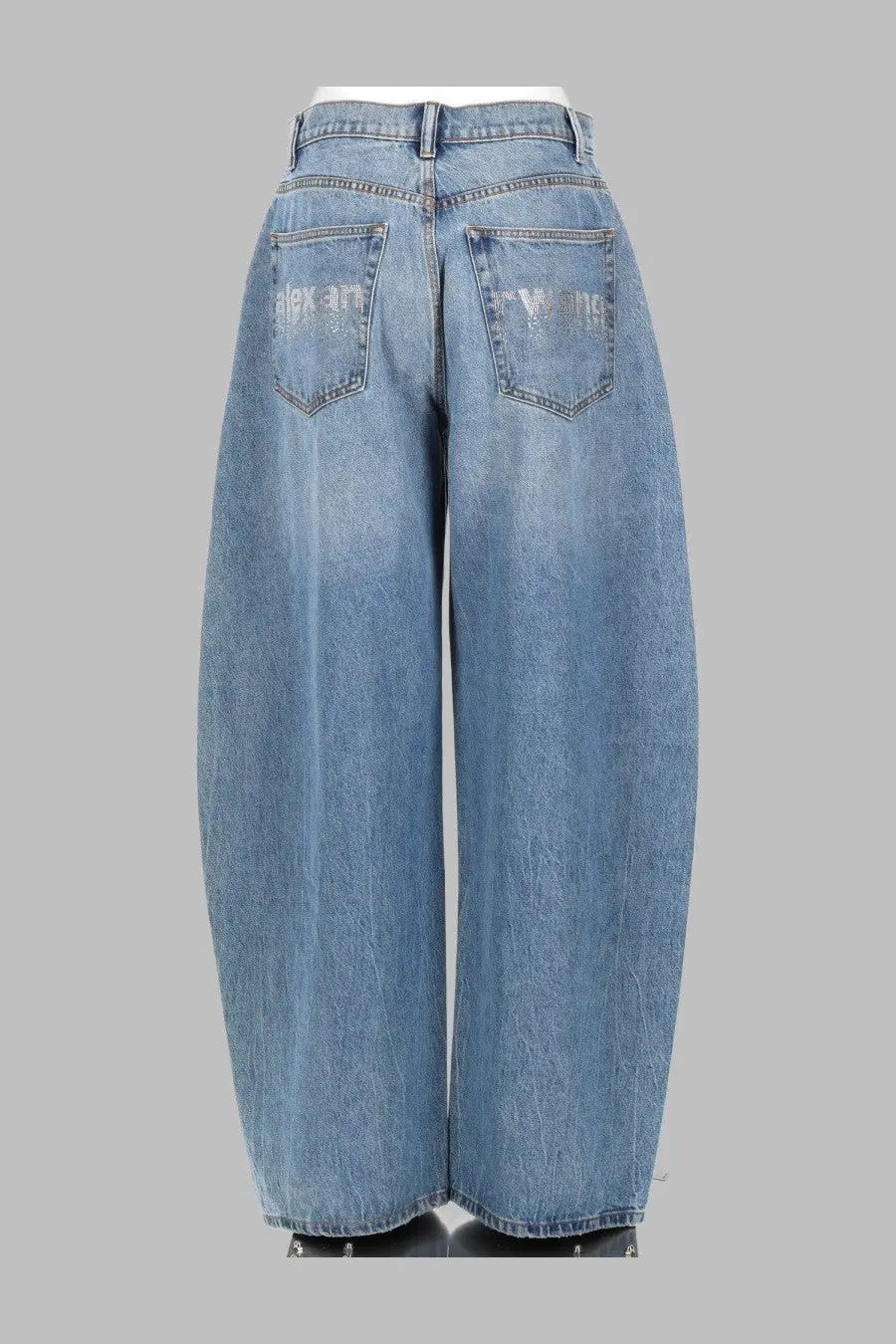 Back side of alexanderwang women’s light-wash denim wide-leg jeans with high waist and subtle distressed back pockets