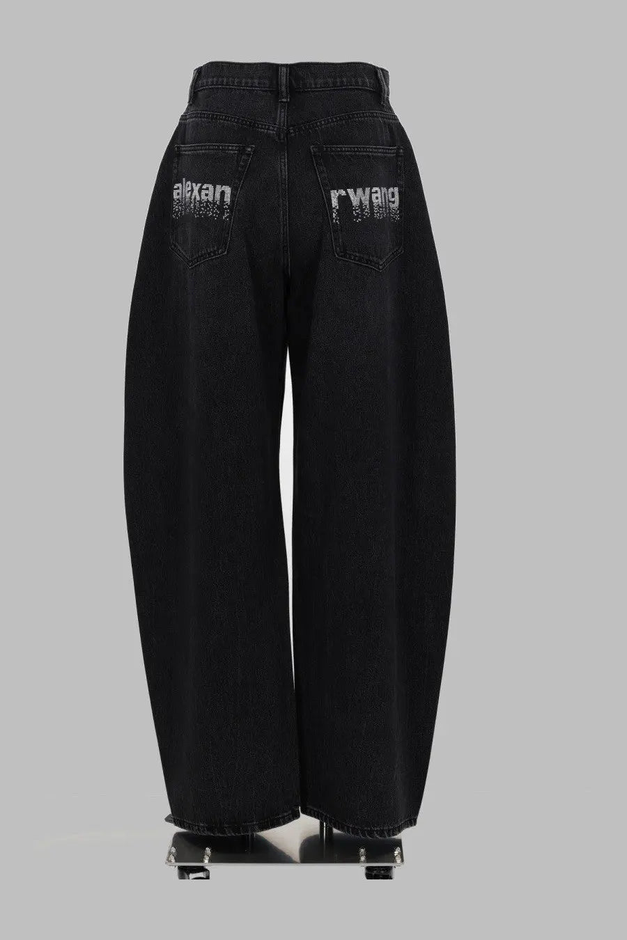 Back side of alexanderwang women’s black denim wide-leg jeans with alexan and rwang rhinestone logos on back pockets