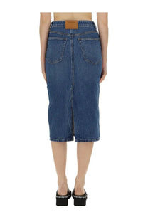 Back view of alexanderwang women’s blue midi denim skirt with straight cut, two back pockets, and brown leather patch
