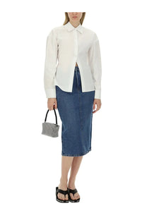 A small structured handbag with a black houndstooth pattern and black handles paired with alexanderwang blue midi skirt