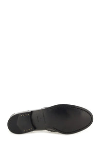 Back view of alexanderwang women’s black leather moccasin carter sole with stitched edges and brand logo near heel