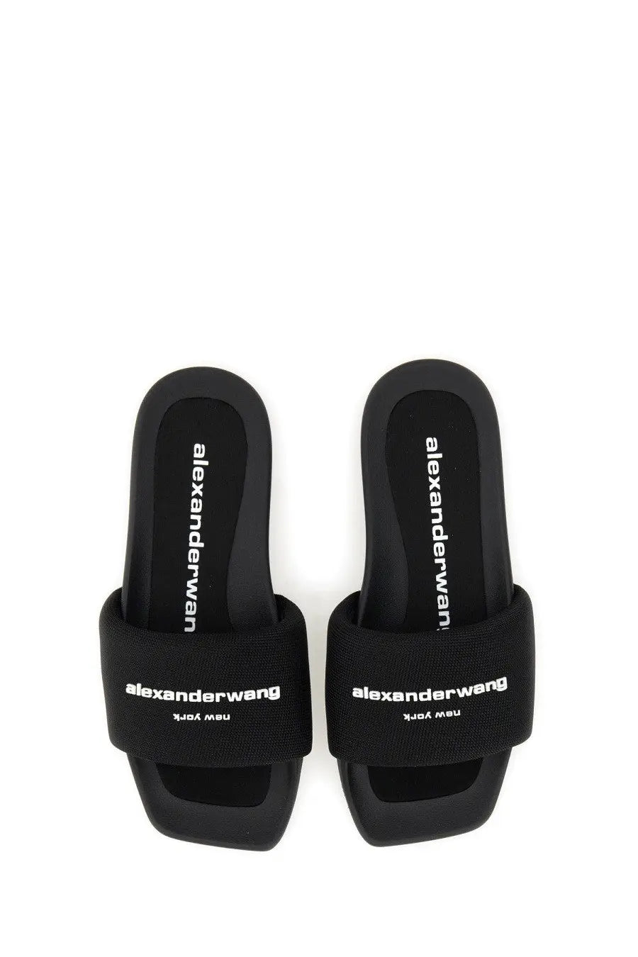 Black alexanderwang women’s nylon slide sandals with white branding on strap and insole in black color