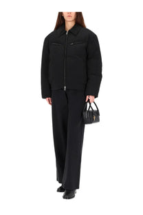 Black leather mini handbag with gold-tone key-shaped clasp paired with alexanderwang women’s padded jacket essential black