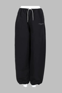 Alexanderwang women’s pantalone track con black drawstring pants with relaxed wide-leg silhouette and white cord detailing