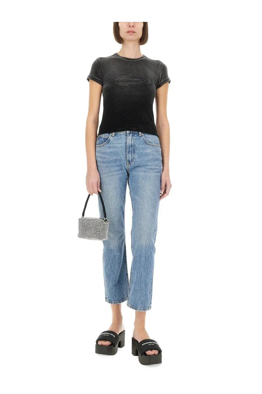 Alexanderwang women’s black shirt displayed with a small rectangular black and white checkered handbag with a short handle