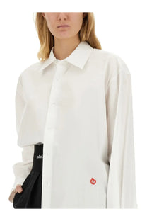 Alexanderwang women’s white oversized button-down shirt with a small red apple logo on the lower left side