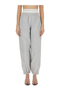 Light gray alexanderwang women’s high-waisted jogger pants with elastic waistband and cuffed hems for sportswear