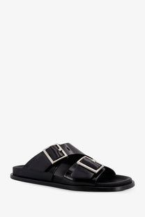 Alohas women’s Alba low leather slide sandal in black with two silver-toned rectangular buckle straps
