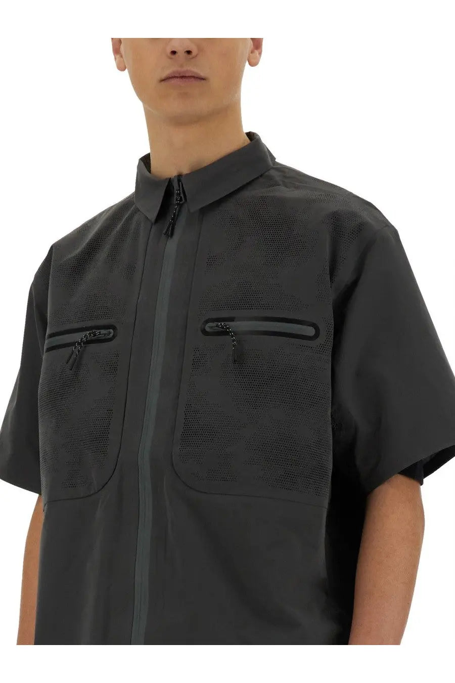 Alpha Industries men’s grey short sleeve shirt with textured mesh pattern and zippered pockets made of lightweight fabric