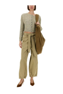 A textured olive green knit cropped cardigan with button front paired with alysis women’s beige belted pants