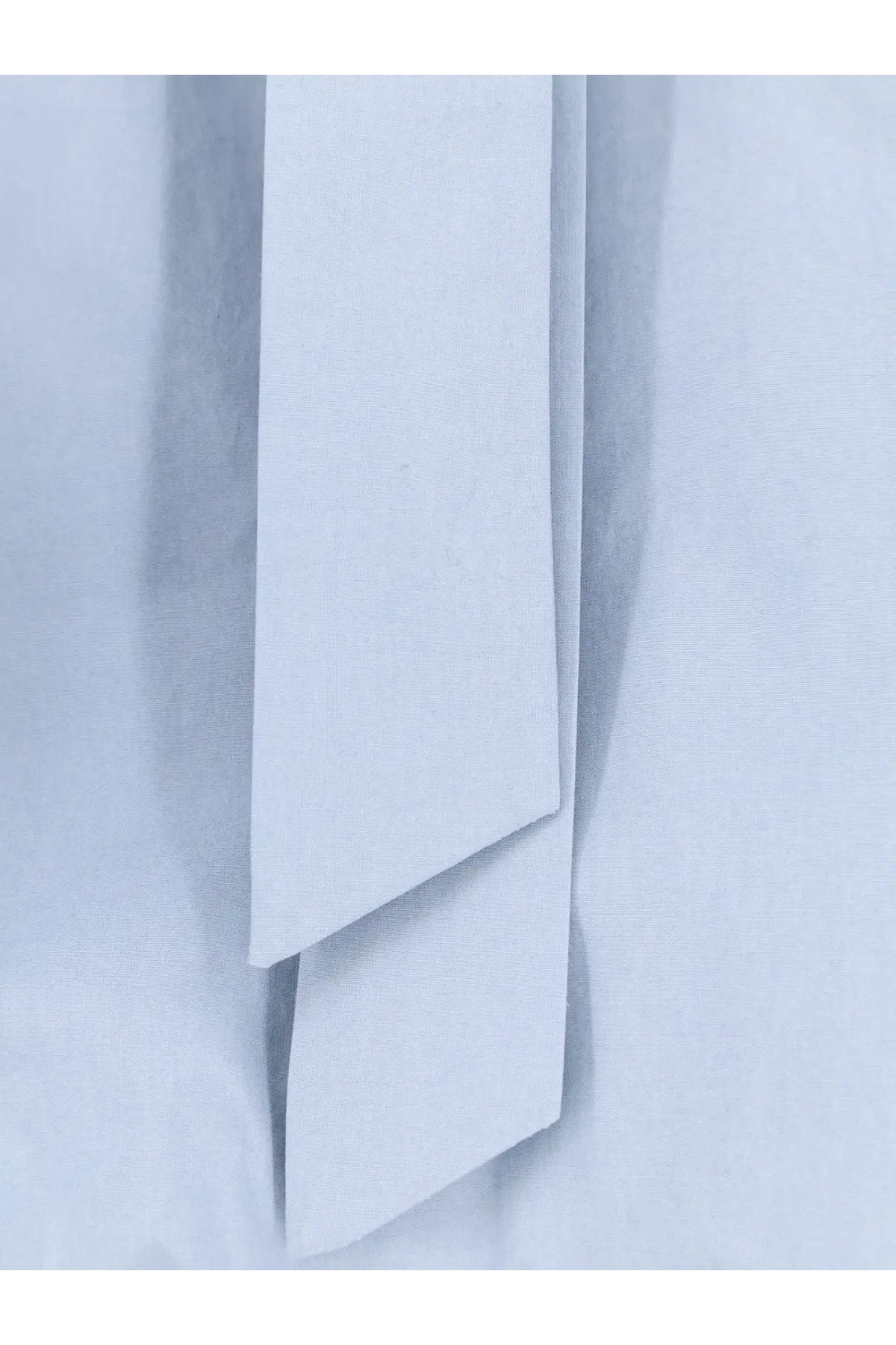 A sleek minimalist white cotton tie with a smooth matte finish paired with alysi women’s cotton shirt cielo