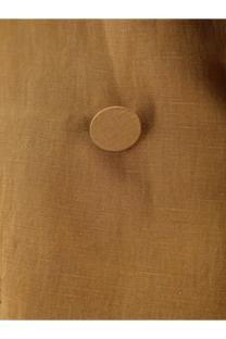 A round tan-colored button with a textured surface on alysi women’s double breasted lyocell and linen blazer