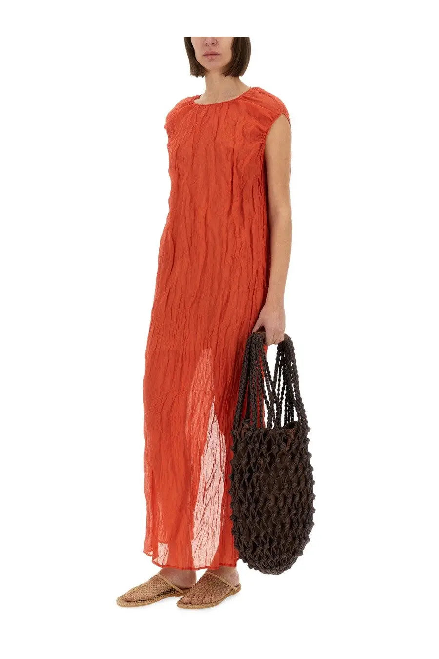 A dark brown woven tote bag with textured braided handles and open-weave body paired with a red alysi metallic gauze longuette dress