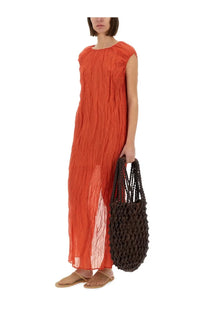 A dark brown woven tote bag with textured braided handles and open-weave body paired with a red alysi metallic gauze longuette dress