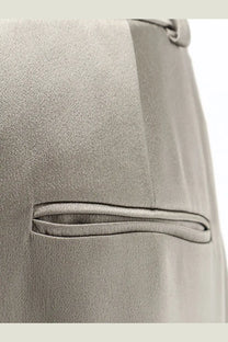 Alysi women’s beige satin trousers featuring a sleek gray satin-finish pocket on a tailored suit