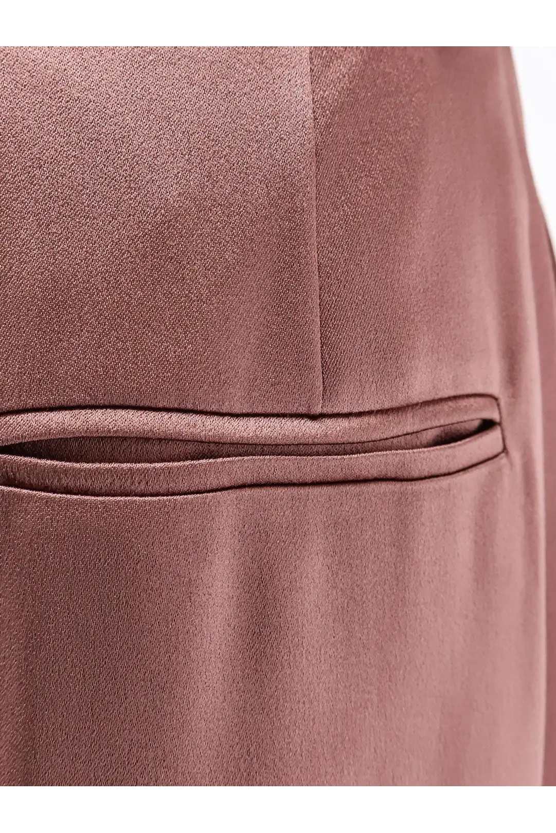 Alysi women’s blue satin trousers close-up showing fine weave and stitched pocket detail on rose gold satin fabric