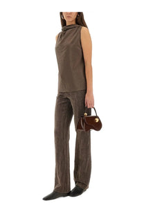 A sleek glossy brown leather mini handbag with gold-tone hardware paired with alysi women’s velvet crinkle slim pants brown