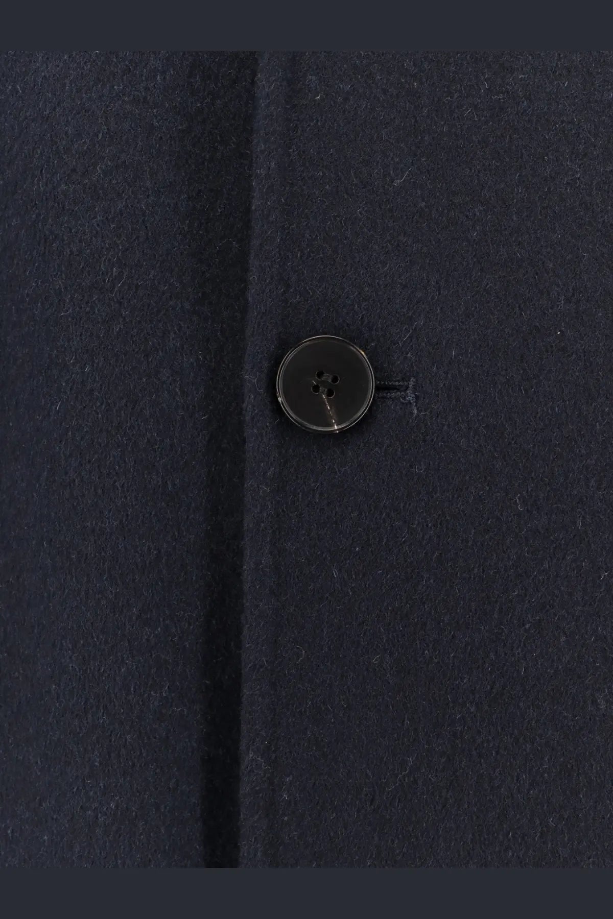 Detail of a dark navy four-hole button with subtle sheen on amaranto men’s outdoor wool coat blue