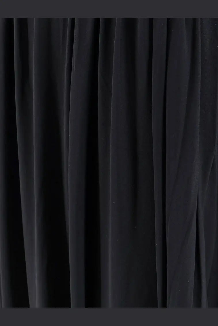 Black velvet curtain with rich plush texture and deep folds shown with amazuìn women’s amelia jersey dress black product