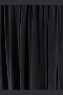 Black velvet curtain with rich plush texture and deep folds shown with amazuìn women’s amelia jersey dress black product
