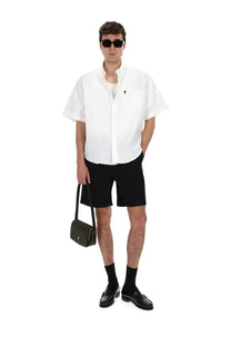 Ami paris men’s camica con ricamato white featuring a black leather crossbody bag with gold-tone hardware and minimalist design