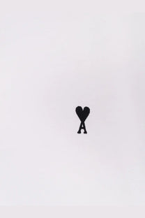 Ami Paris men’s white cotton shirt with black embroidered heart shaped logo and stylized a on the front