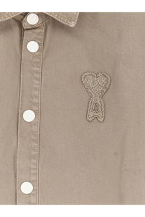Beige cotton button-up shirt by ami paris featuring a crocheted heart-shaped logo patch on the chest