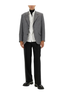 Ami Paris men’s double breasted grey wool blazer with subtle pattern worn over white shirt and black trousers