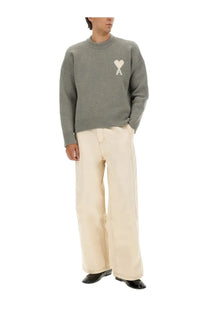 Gray knit sweater with white heart logo on chest paired with Ami Paris men’s wide fit white jeans