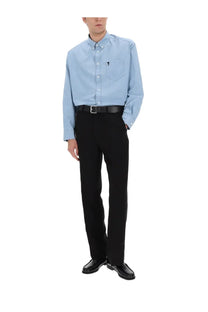 Light blue button-down shirt with subtle embroidered logo on chest pocket paired with ami paris men’s linen blend straight black pants